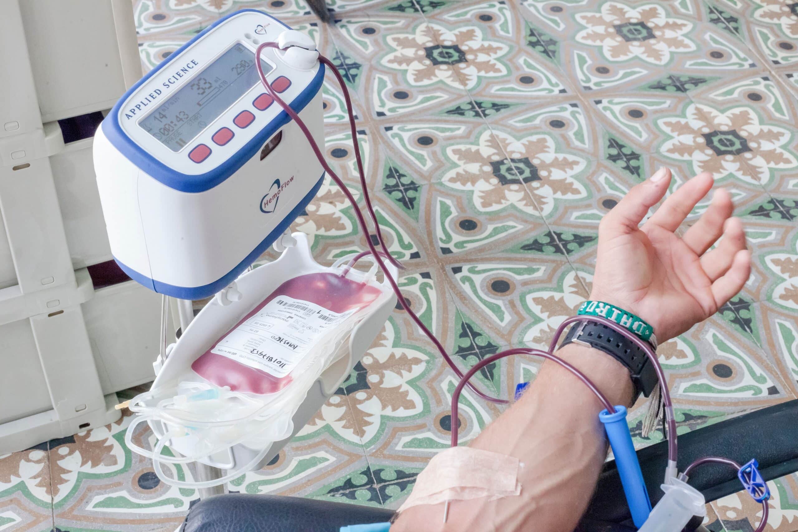 A man's arm is hooked up to an IV, indicating blood circulation and heart health.